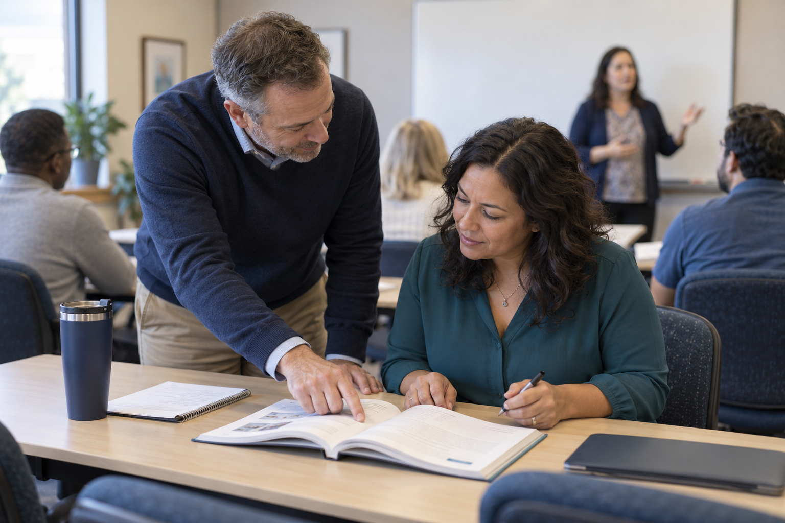 Photo concept of a supporting instructor helping a student with an open textbook